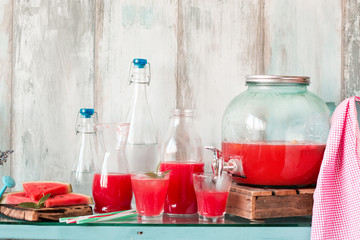 Watermelon drink in glasses with slices of watermelon mint and lemon,