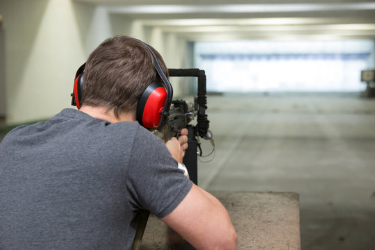 Man is aiming a gun in the shooting-range