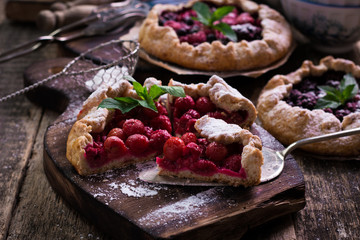 Blueberry,cherry,raspberry and blackcurrant galette on w wooden background.