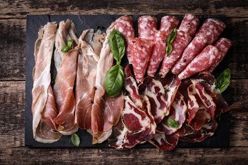 Traditional spanish tapas or italian antipasti on wooden vintage table