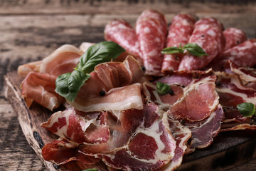 Traditional spanish tapas or italian antipasti on wooden vintage table