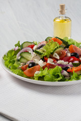 fresh Greek salad on a light background