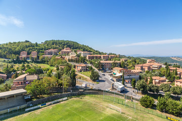 Fototapeta na wymiar Montalcino, Italy. Typical landscape: mountains, tiled roofs, football