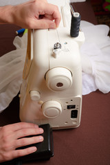 Woman threading on sewing machine