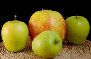 Three green and one big apples