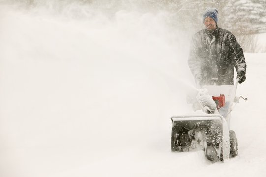 A Man Snow-Blowing