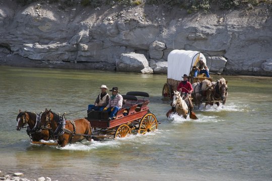 Cowboys And A Chuck Wagon Crossing A River