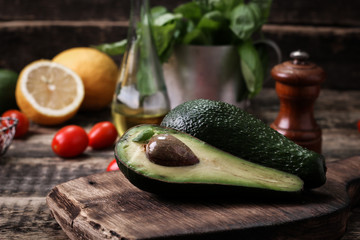 food background with fresh organic avocado on old wooden table, top view, copy space