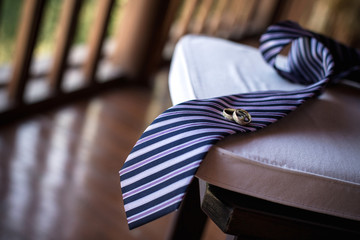 Man's tie and wedding rings