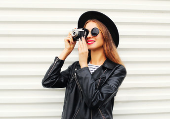 Fashion look, pretty young woman model with retro film camera we
