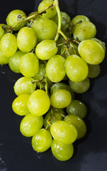 Bunch of grapes on a black slate stone