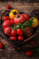 Colorful tomatoes, red tomatoes, yellow tomatoes, orange tomatoes, green tomatoes. Tomatoes background. vintage wooden background
