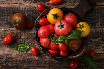 Colorful tomatoes, red tomatoes, yellow tomatoes, orange tomatoes, green tomatoes. Tomatoes background. vintage wooden background
