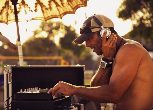 A Disc Jockey Playing Music At Explora Beach Bar; Tarifa, Cadiz, Andalusia, Spain