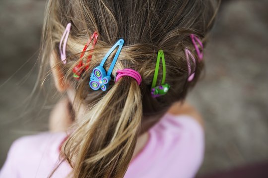The Back Of A Young Girl's Head Showing Many Hair Accessories In Her Hair; Palm Beach, Gold Coast, Queensland, Australia