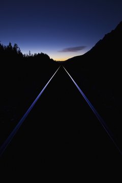 Train Tracks At Sunset; Banff, Alberta, Canada