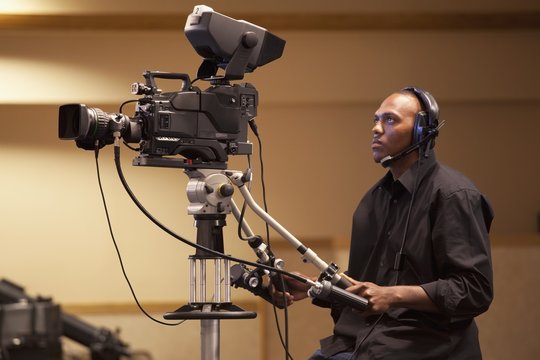 A Man Operating A Tv Camera