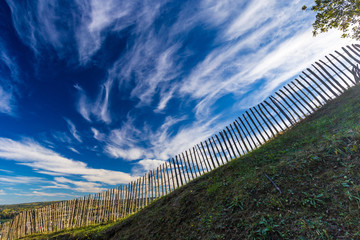 Old wooden fence on dramatic blue sky background