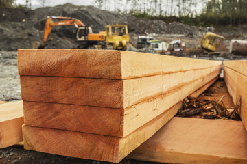 A neat stack of fresh lumber is shown on a side profile revealing the raw grain of the log and texture in the lumber planks ready for construction; Port McNeill, British Columbia, Canada