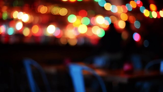 Soft blur table inside bar, festive lights.