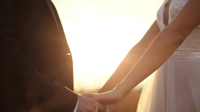 Newly married couple holding hands