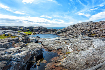 Cloudy blue sky above a surface of the sea