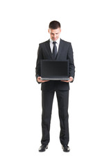Young businessman wih a laptop isolated on white