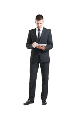 Young businessman with a tablet computer on white