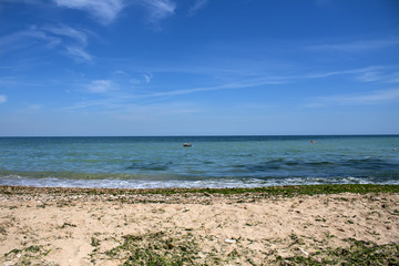 Fototapeta na wymiar Sky and sea. Sand. Beach. People relax on the beach
