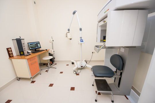 Dentistry clinic cabinet with orthopantomograph, dental panoramic x-ray machine to produce images in single shot entire dental system. Table with a computer which shows the x-ray photograph teeth