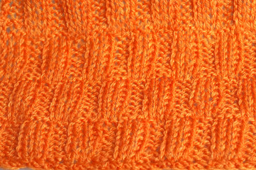 Piece of knitting work - orange yarn stitches - macro