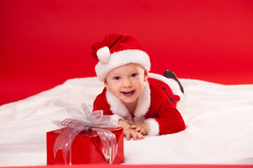 Beautiful little baby celebrates Christmas. New Year's holidays. gift