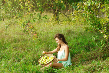 Happy woman in garden during a picking apples