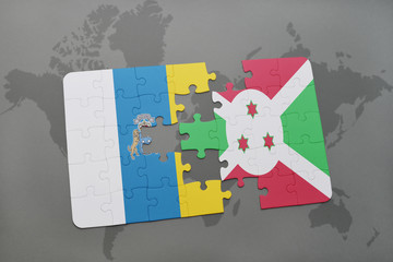 puzzle with the national flag of canary islands and burundi on a world map background.