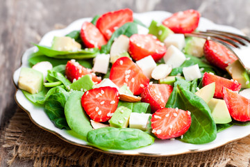 Spring  salad with spinach leaves and strawberries and feta chee