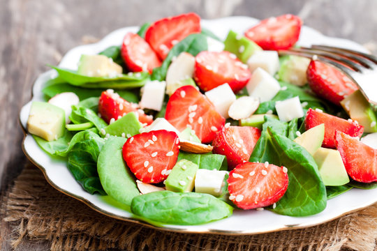 Spring  salad with spinach leaves and strawberries and feta chee