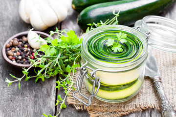 Sliced  zucchini with parsley and garlic preserves in glass jar