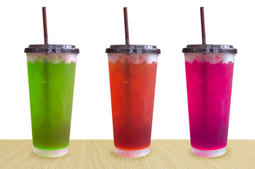 fresh sweet water colourful bright and ice in plastic glass isolated on white background,Summer drinks with ice on white background