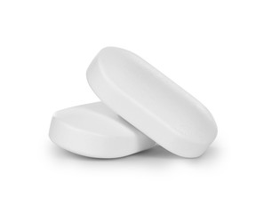 close-up of two pills isolated on white background
