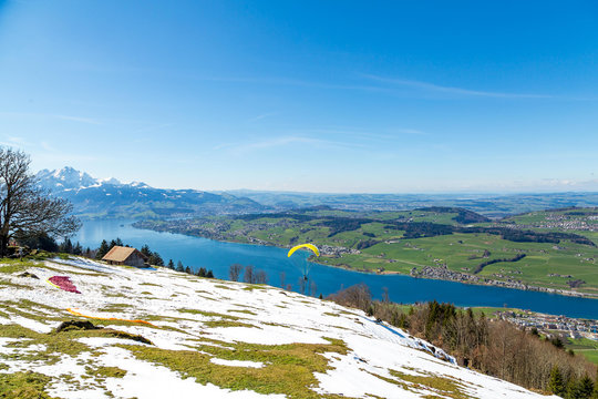 Beautiful nature view in Swiss Alps with paraplane flying over t