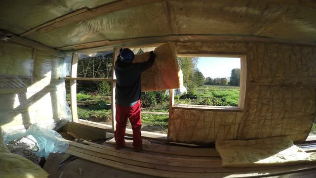 Builder insulating wooden house with mineral rock wool , 4K