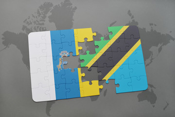 puzzle with the national flag of canary islands and tanzania on a world map background.