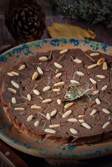Tuscan Chestnut Cake (Castagnaccio alla toscana) on a wooden background,
Typical Italian Sweet Chestnut Cake made with Chestnuts, Traditional Italian recipes. 
