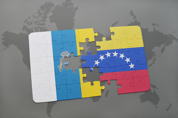 puzzle with the national flag of canary islands and venezuela on a world map background.