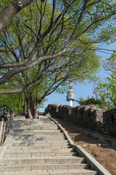 Stairway, old fortress wall (or City Wall) and N Seoul Tower (Namsan Tower or Seoul Tower) at the Namsan Hill (or Namsan Park or Namsan Mountain) in Seoul, South Korea.