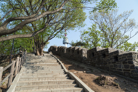 Stairway, old fortress wall (or City Wall) and N Seoul Tower (Namsan Tower or Seoul Tower) at the Namsan Hill (or Namsan Park or Namsan Mountain) in Seoul, South Korea.