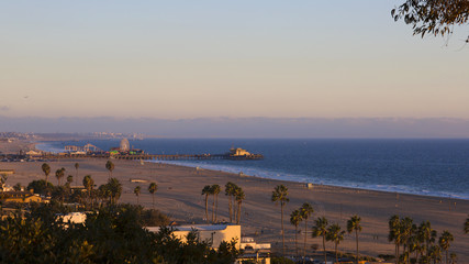 The Pacific Ocean is during sunset. Landscape with blue sea, the beach and the dusk sky, the USA, Santa Monica. 