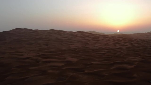 Time lapse sunrise over desert sand dunes, shot in Sahara, Morocco.