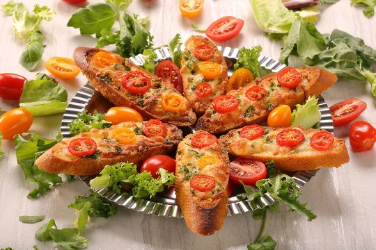 Fresh crispy toast with cheese and tomatoes on a plate