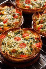 Casserole with cheese, spinach and tomatoes
